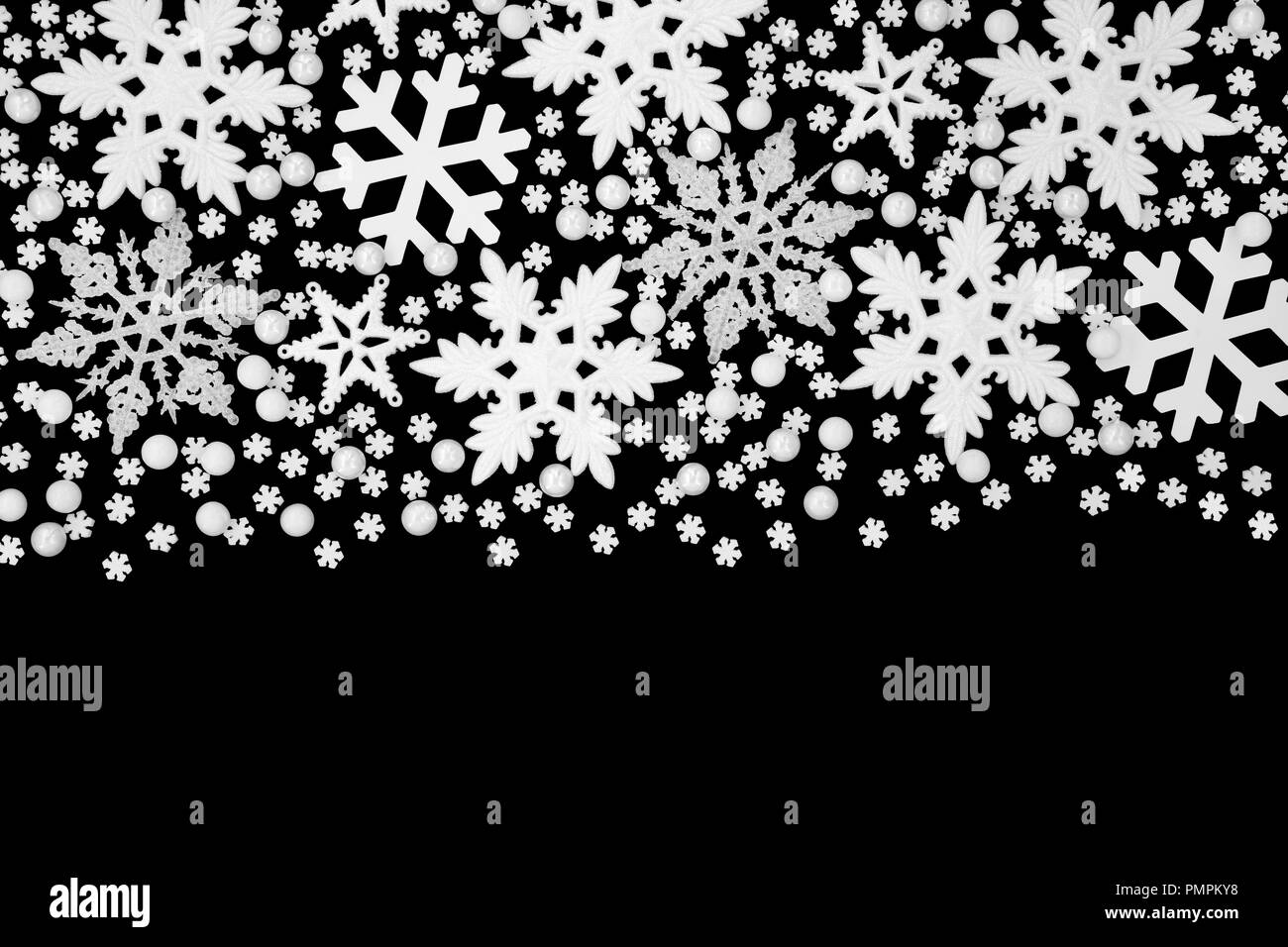 Christmas white snowflake and ball bauble abstract border on black background with copy space. Stock Photo