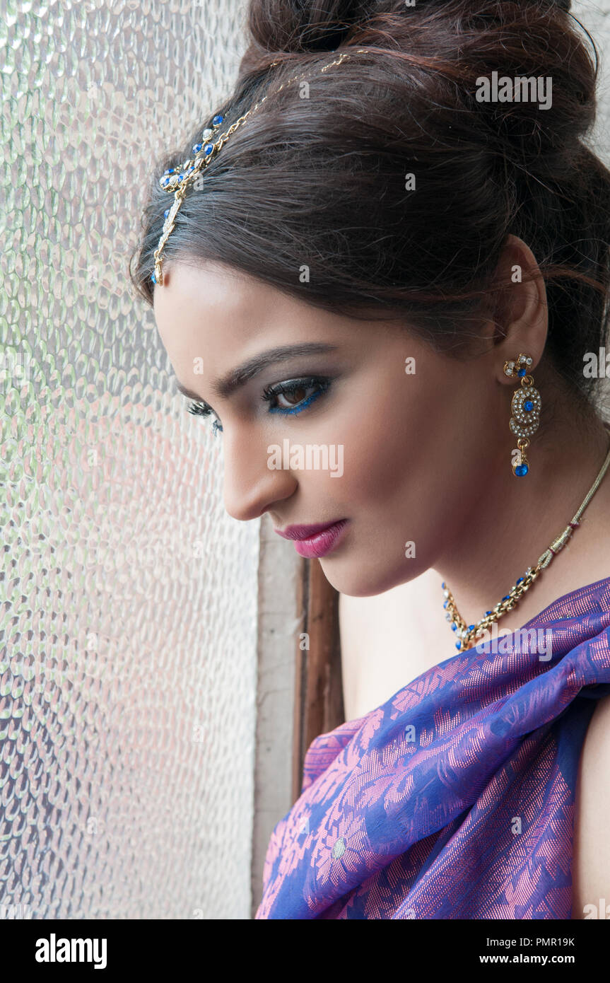 Beautiful Indian woman by the window Stock Photo