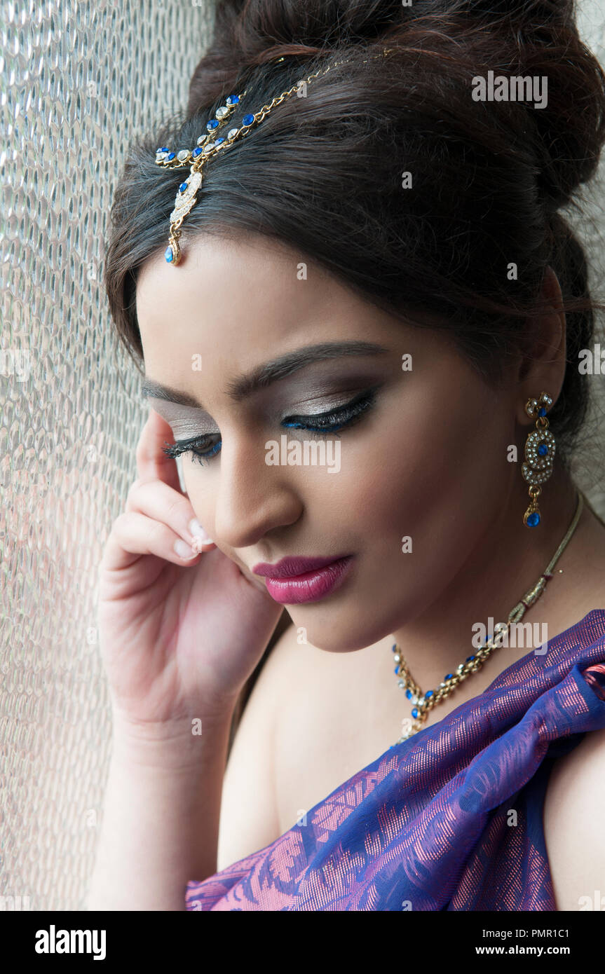 Pensive Indian woman by the window Stock Photo
