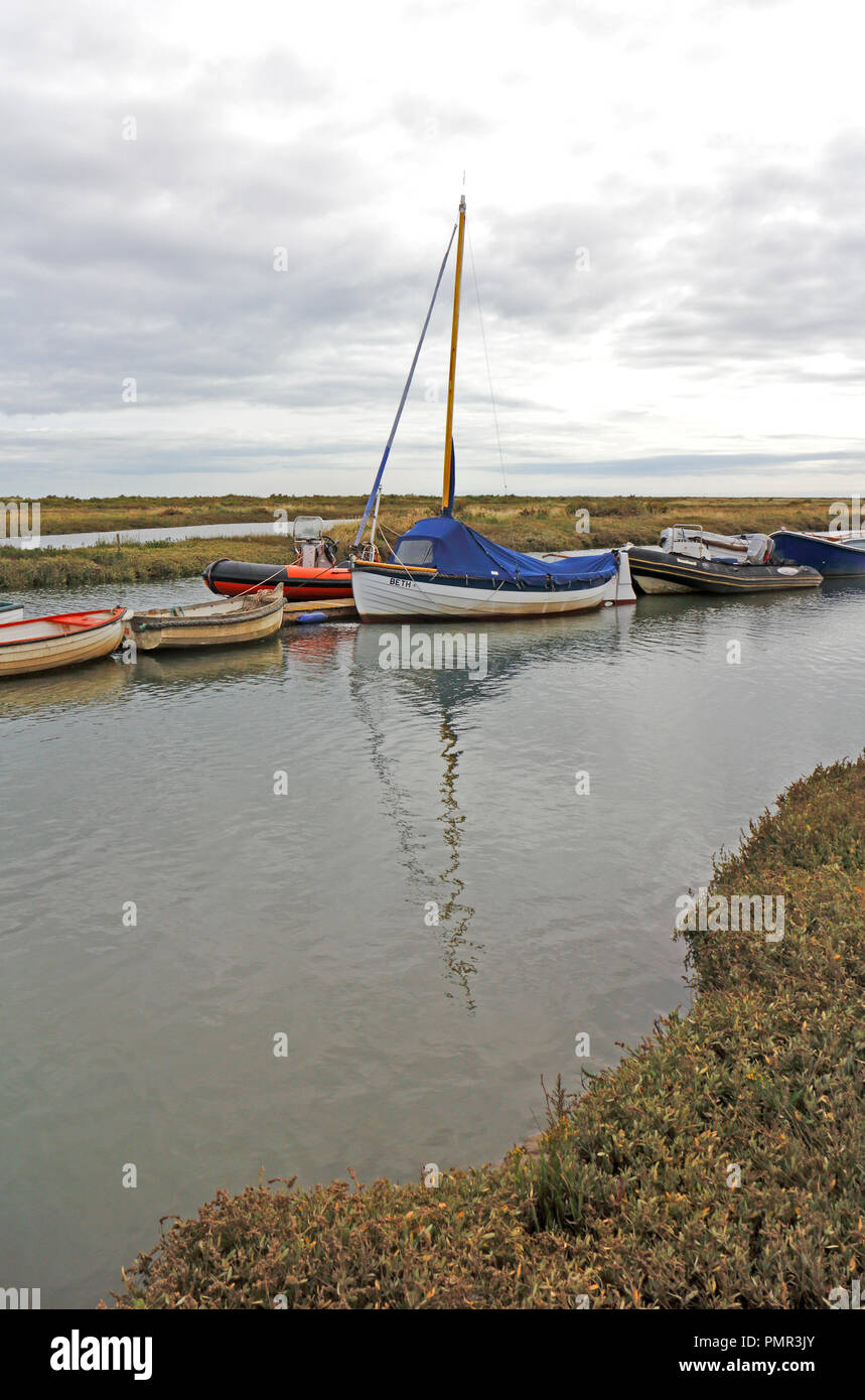 A view of boats moored in the Creek by salt marshes on the North Norfolk coast at Morston, Norfolk, England, United Kingdom, Europe. Stock Photo