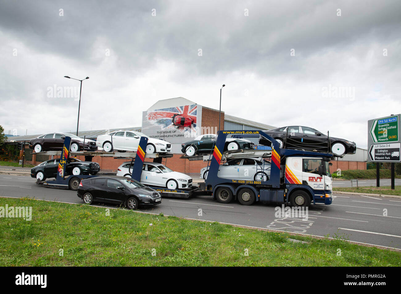 A car transporter carrying Jaguar Landrover cars leaves the Castle Bromwich factory in Birmingham. Stock Photo