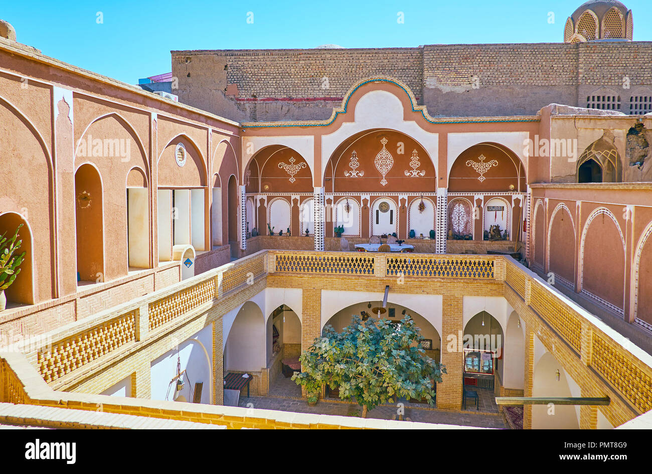 KASHAN, IRAN - OCTOBER 22, 2017: The inner yard in residential mansion, decorated with Persian patterns in shady terraces, on October 22 in Kashan. Stock Photo