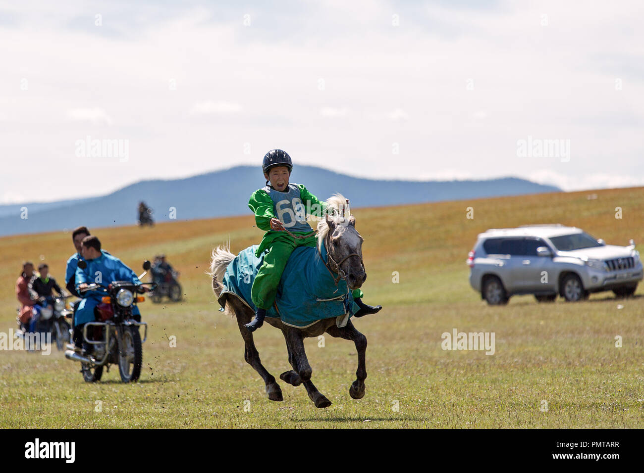 Young boy without shoes is riding a horse participant in the