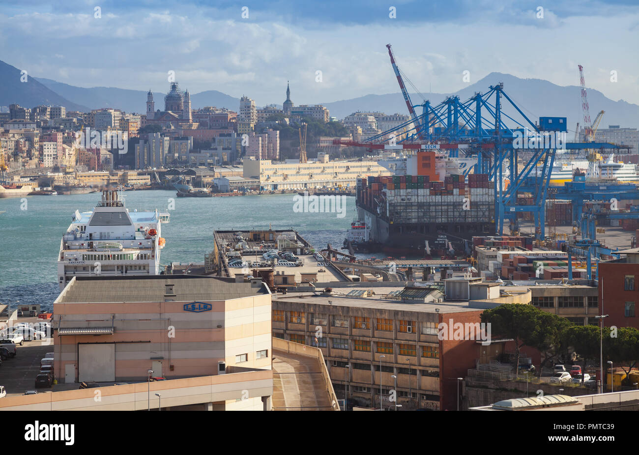 Genova, Italy - January 18, 2018: Genova port view with moored ferry and blue gantry cranes Stock Photo