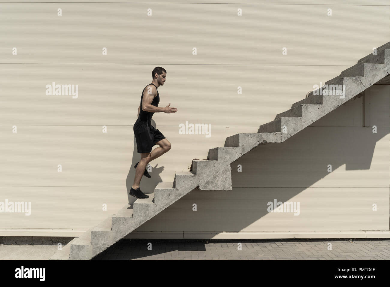 Black man running up stairs hi-res stock photography and images - Alamy