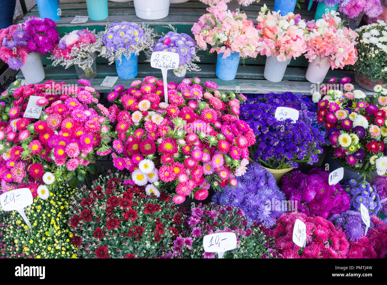 Different autumn flowers on sale on central market in bouquets with