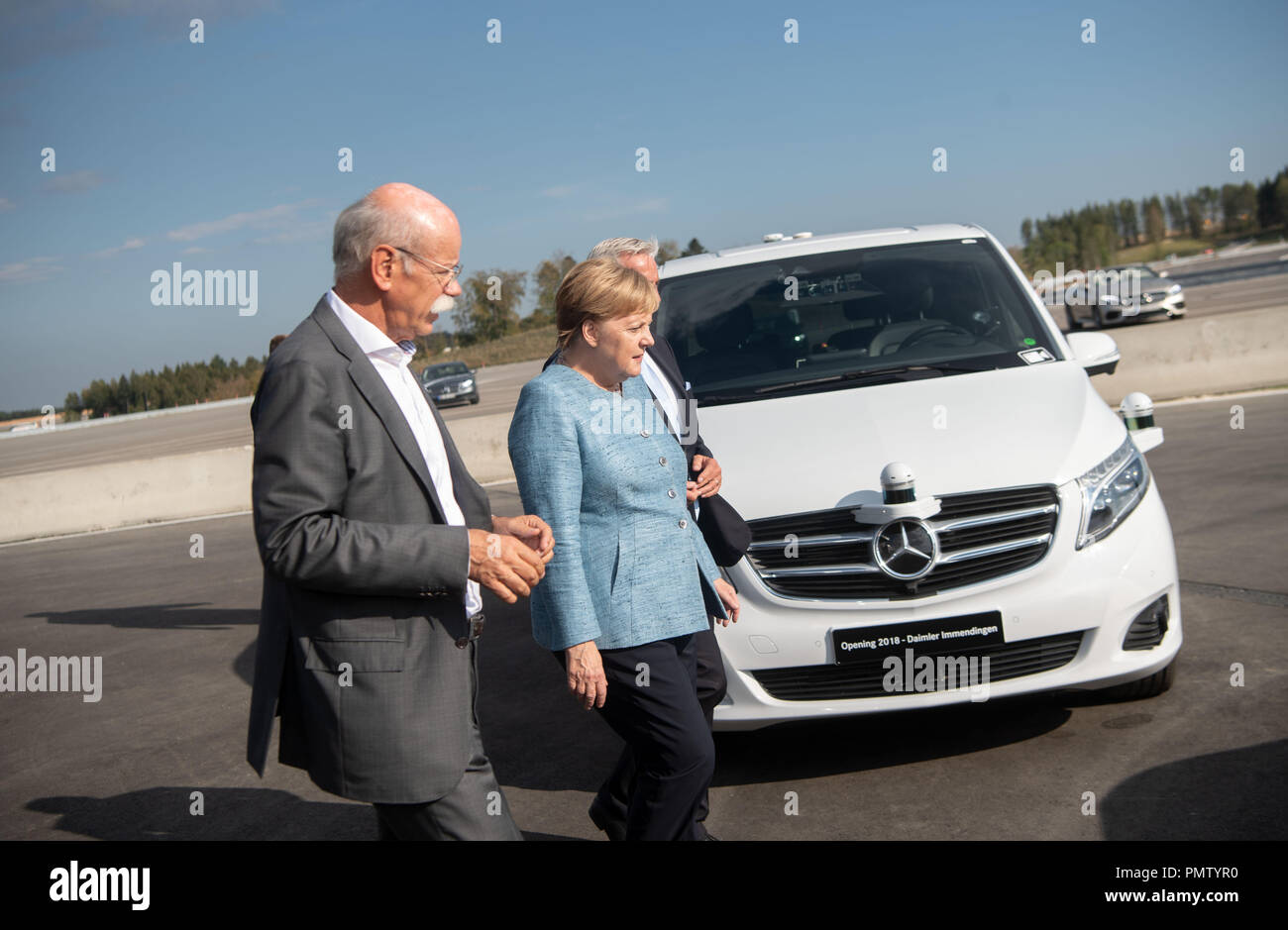 19 September 2018, Baden-Wuerttemberg, Immendingen: German Chancellor Angela Merkel (CDU), Dieter Zetsche, Chairman of the Board of Management of Daimler AG (l) and Thomas Strobl (CDU, undercover), Minister of the Interior of Baden-Württemberg, pass a Mercedes-Benz V-Class test vehicle when a new testing and technology center of Daimler AG is commissioned. Photo: Marijan Murat/dpa Credit: dpa picture alliance/Alamy Live News Stock Photo