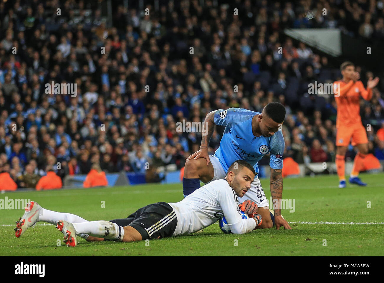London, UK. 19th September 2018, Etihad Stadium, London, England; UEFA Champions League, Manchester City v Lyon; Anthony Lopes (01) of Lyon makes a save as Gabriel Jesus (33) of Manchester City slides in for the ball   Credit: Mark Cosgrove/News Images Stock Photo