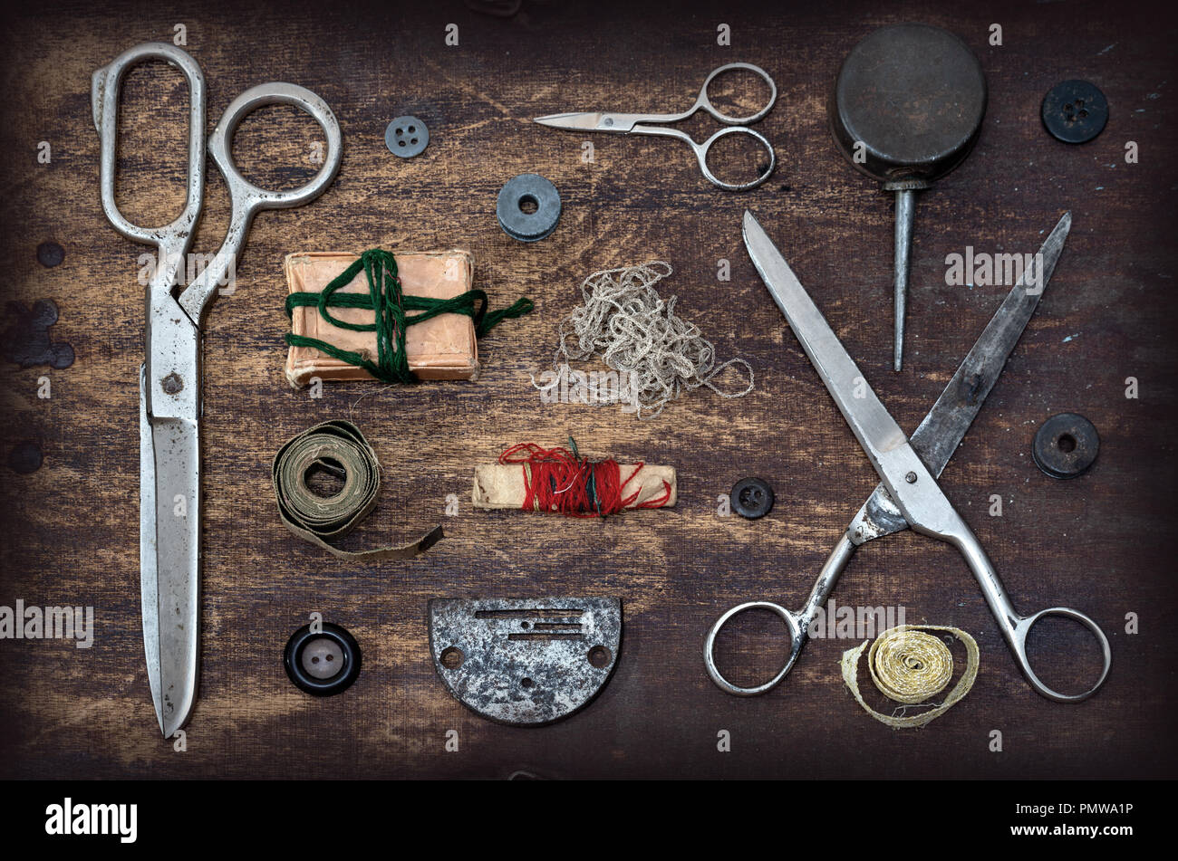 Old Sewing accessories on wooden table Stock Photo