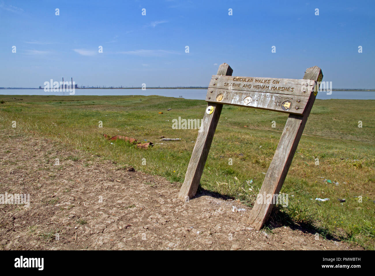 Signpost describing a circular walk on the Saxon Shore Way in Kent with the Thames estuary in background. Stock Photo