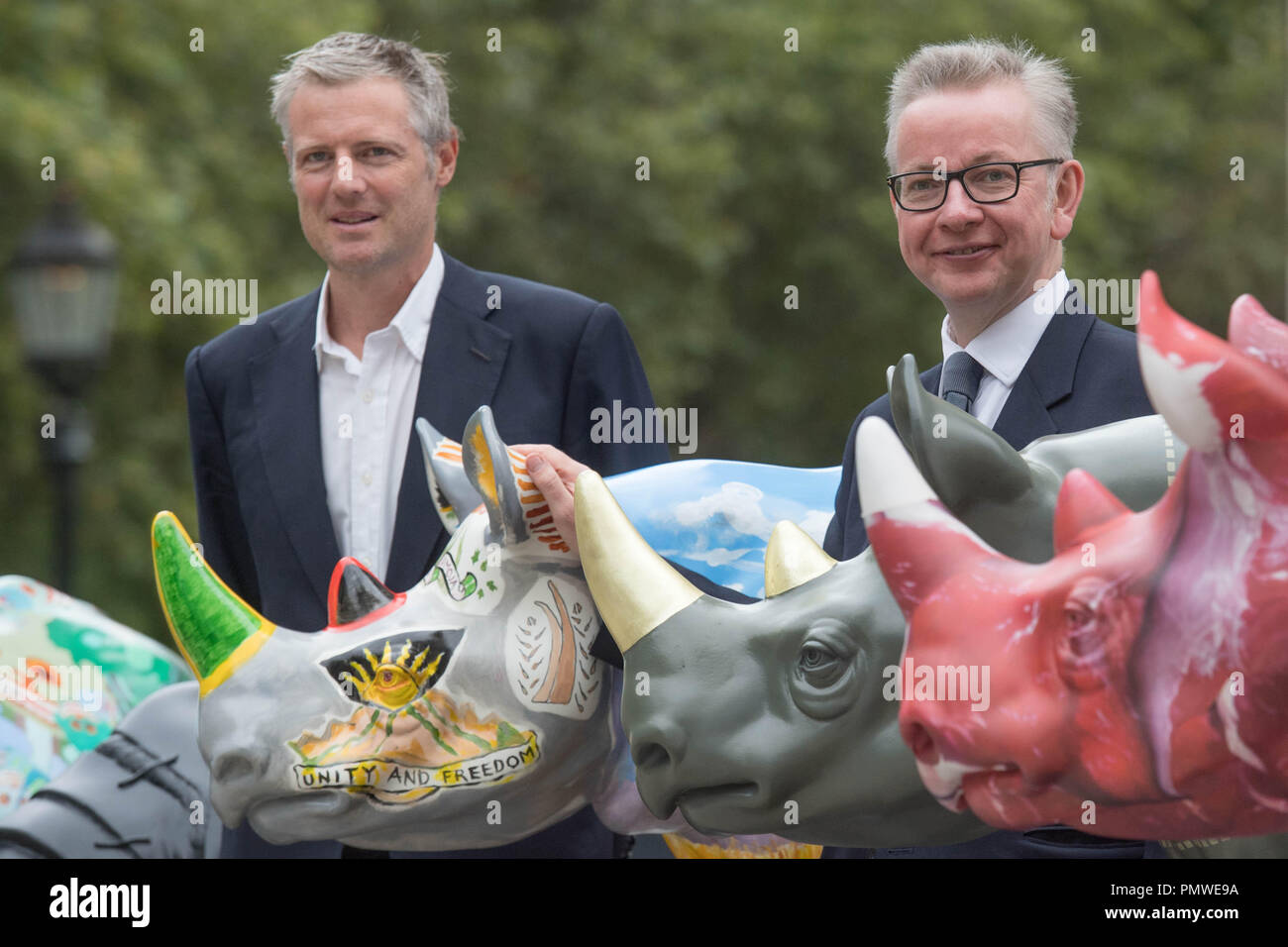 Environment Secretary Michael Gove (right) and Zac Goldsmith with Tusk Trust rhino art statues outside the Foreign Office in London, ahead of the Illegal Wildlife Trade Conference. Stock Photo