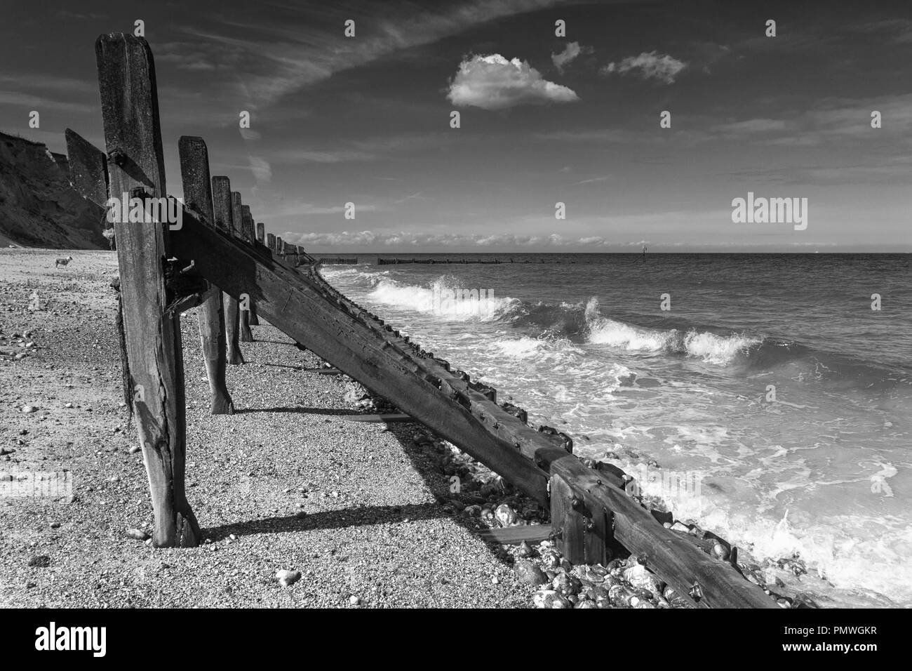 Wooden groynes and revetments on West Runton Beach, North Norfolk, East Anglia, UK Stock Photo