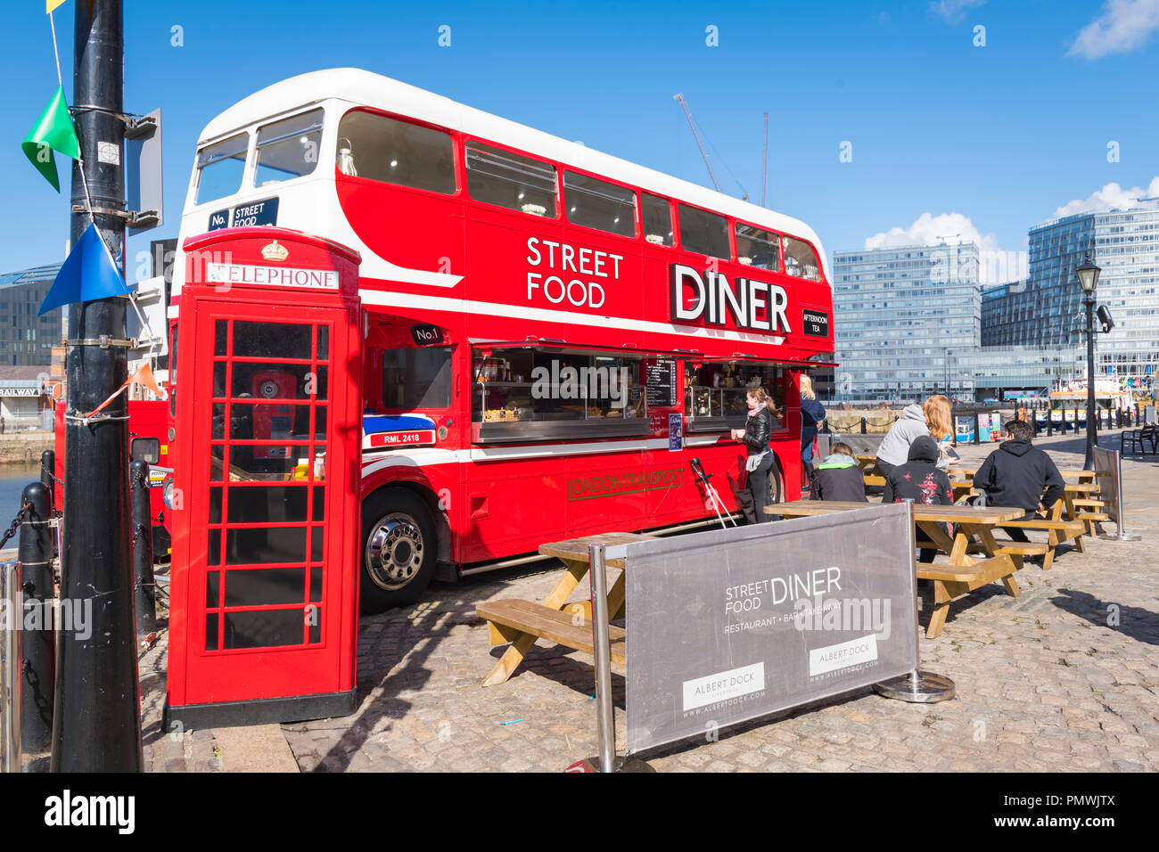 Liverpool Canning Dock double decker London Transport bus Street Food Diner restaurant bar takeaway takeout wooden tables benches red phone book Stock Photo