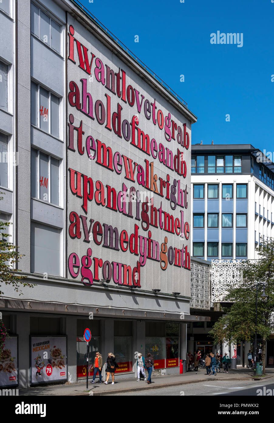 Giant lettering outside H&M in Stavanger: I want to love to grab a hold of  me and bite me walk right up and fight me leave me dying on the ground Stock