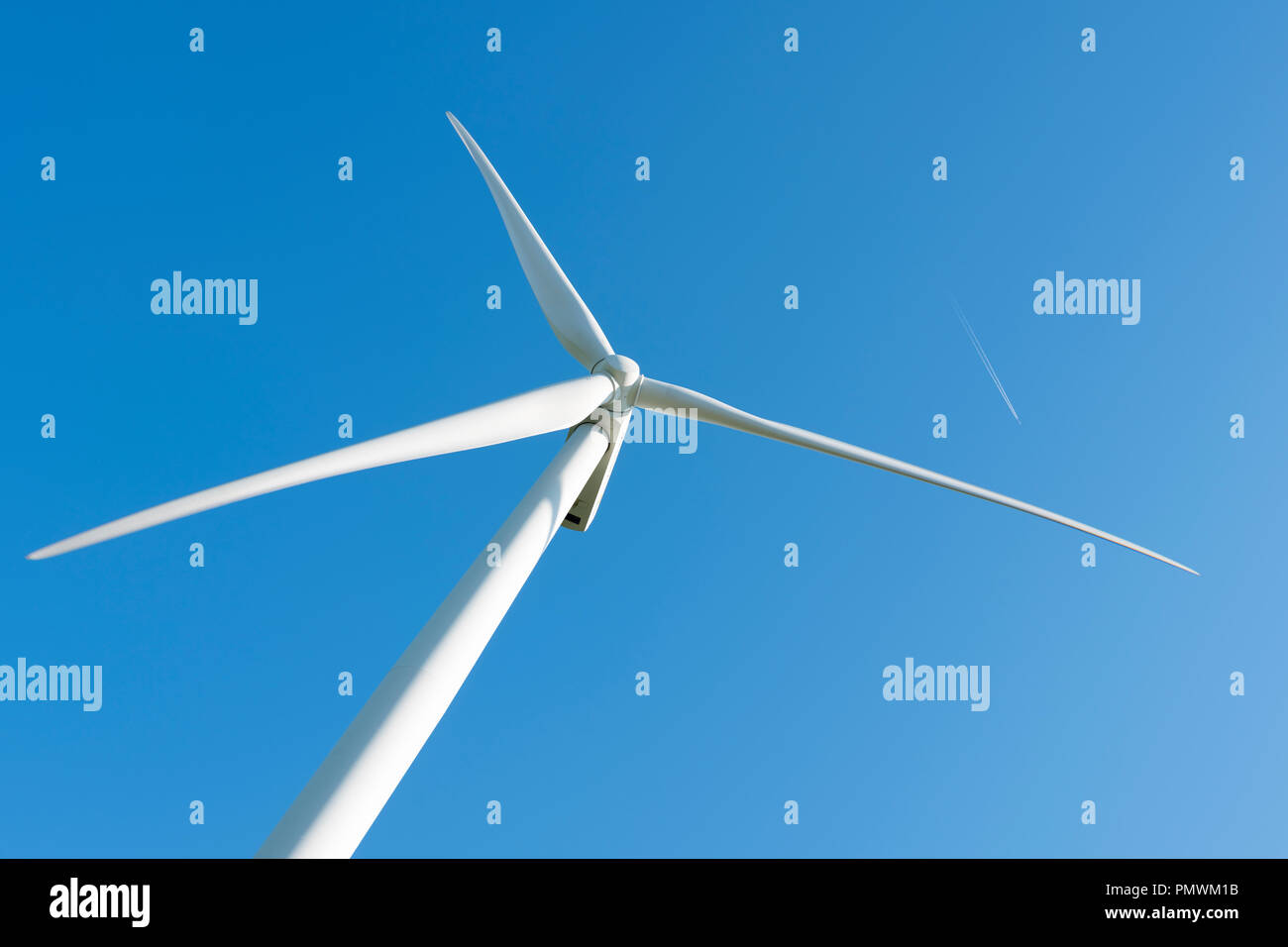 white wind turbine against blue sky Stock Photo - Alamy