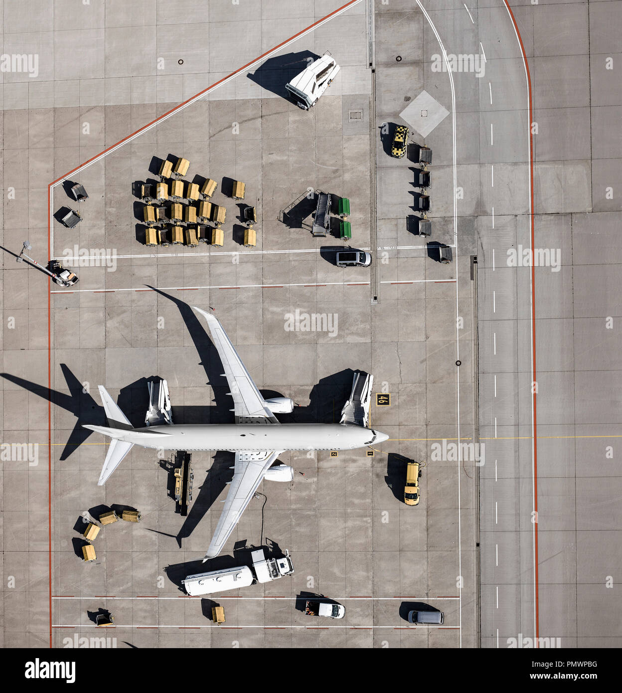 View from above commercial airplane being serviced, prepared on tarmac at airport Stock Photo