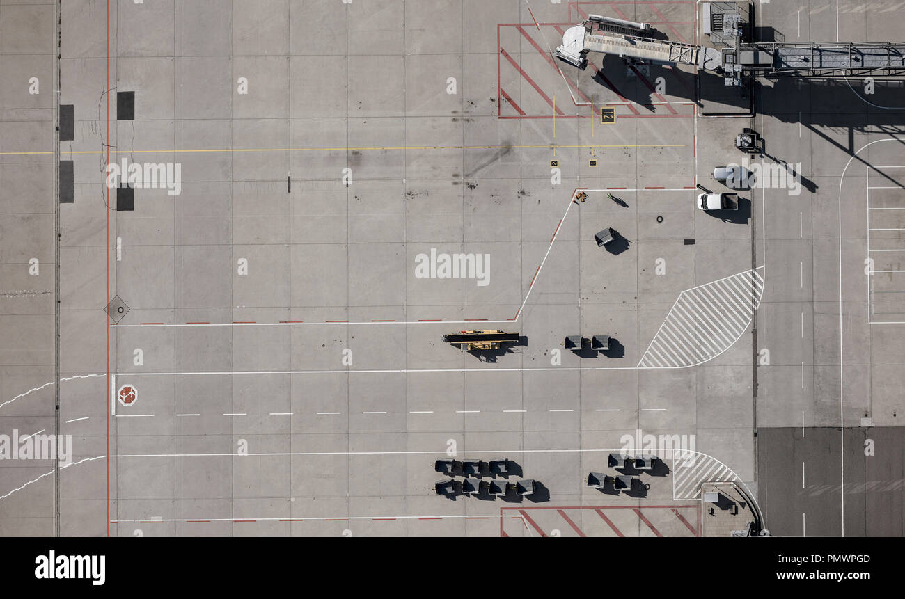 View from above airport service vehicles and passenger boarding bridge on tarmac at airport Stock Photo