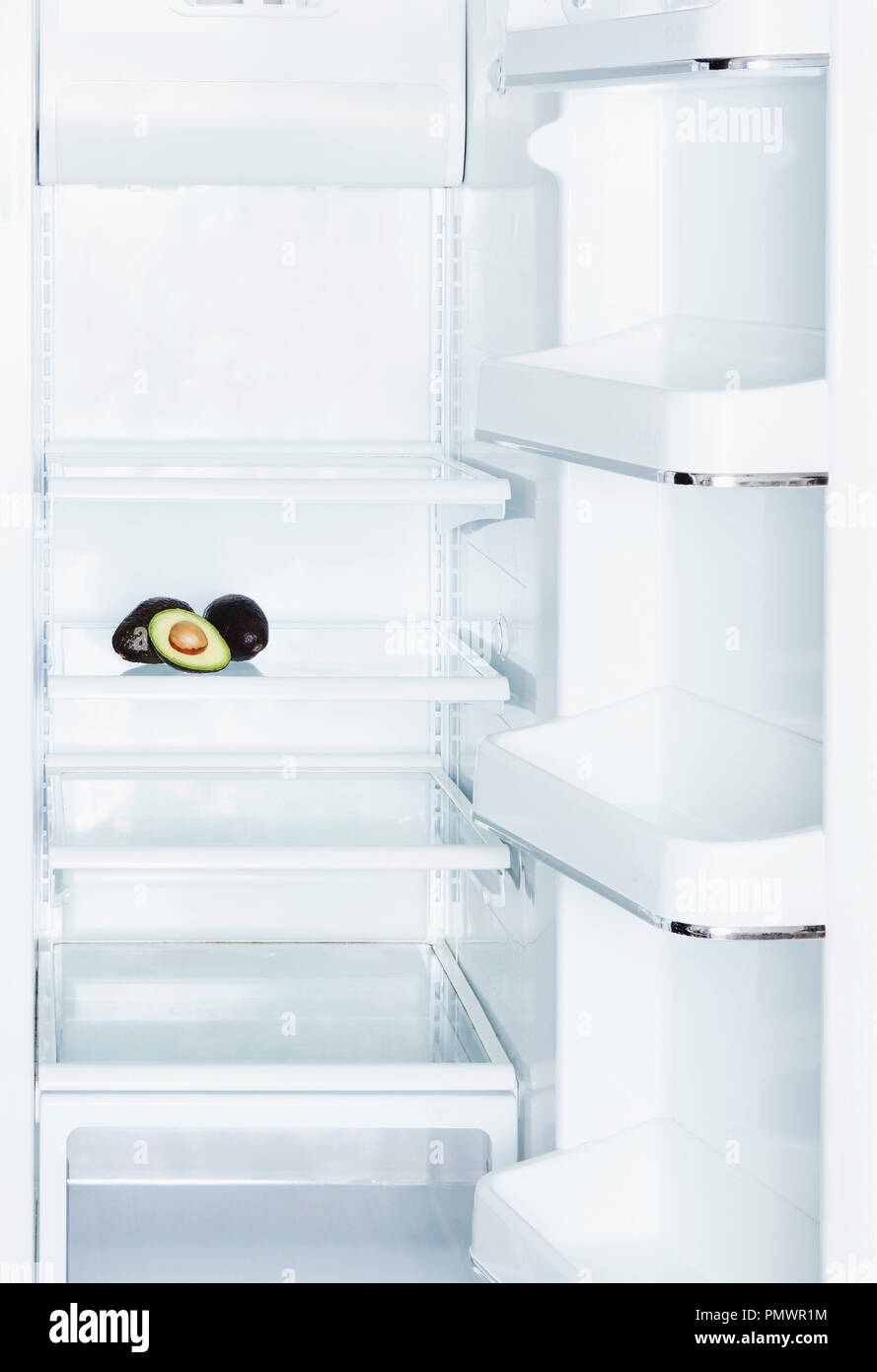 Avocados in open, empty white refrigerator Stock Photo Alamy