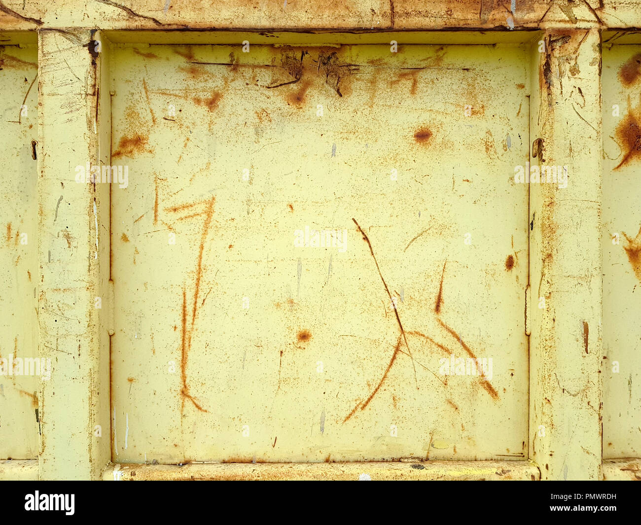 Old rusty yellow painted metallic construction as a full frame background. Stock Photo