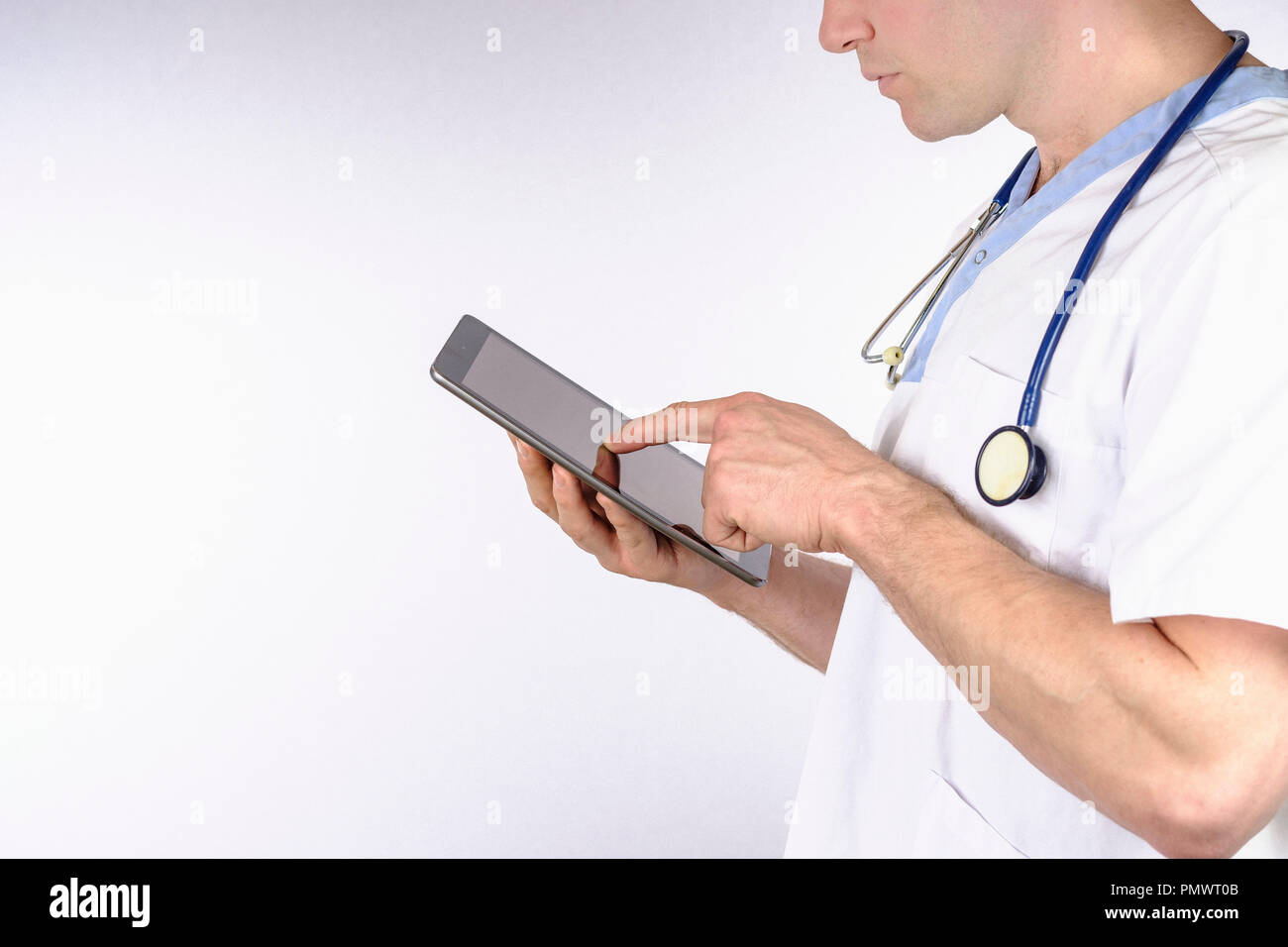 Doctor using digital tablet against white background Stock Photo