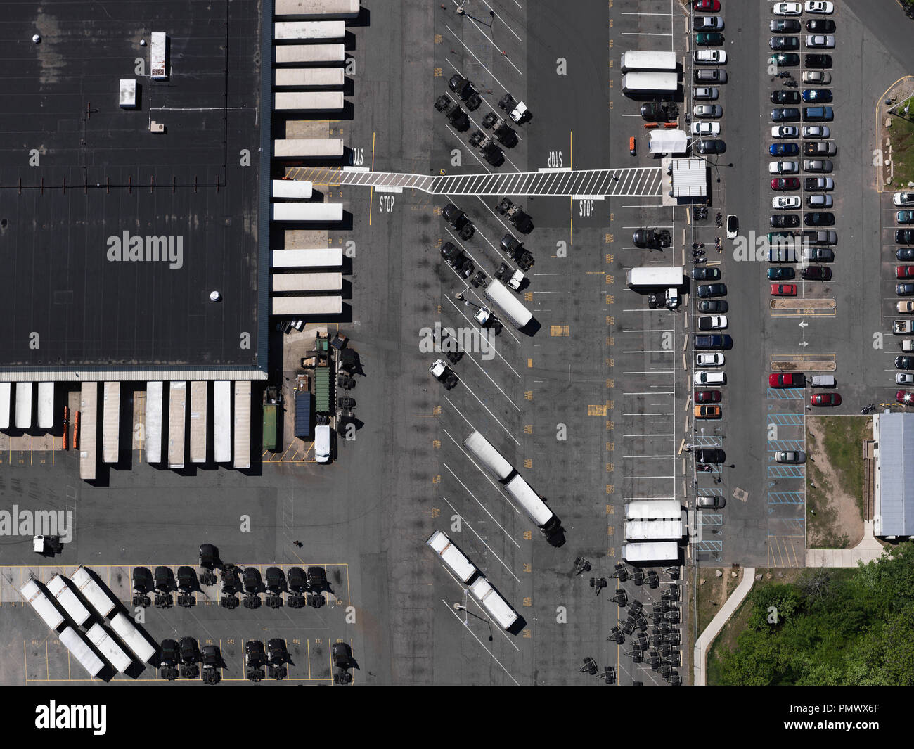 Aerial view sunny parking lot and commercial warehouse, New York City, New York, USA Stock Photo