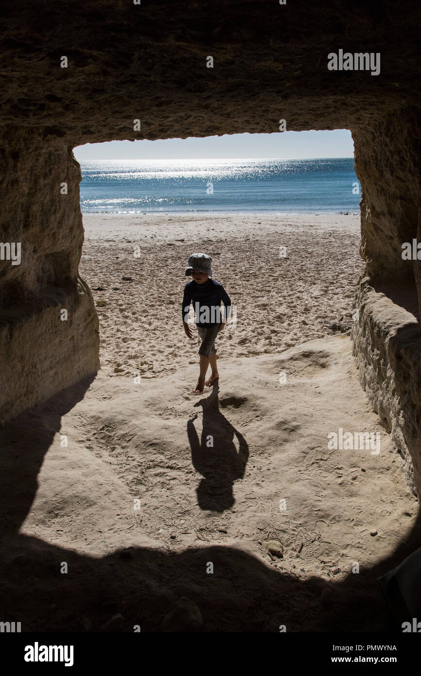 Boy On Sunny Ocean Beach Walking Into Cave Stock Photo Alamy boy-on-sunny-ocean-beach-walking-into-cave-stock-photo-alamy
