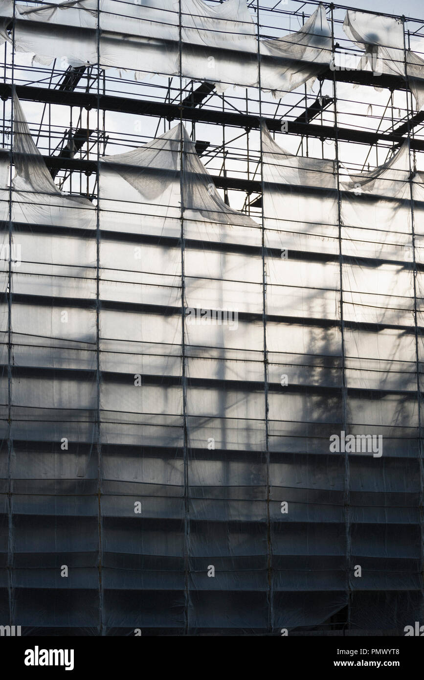 Protective sheeting over highrise building under construction Stock Photo