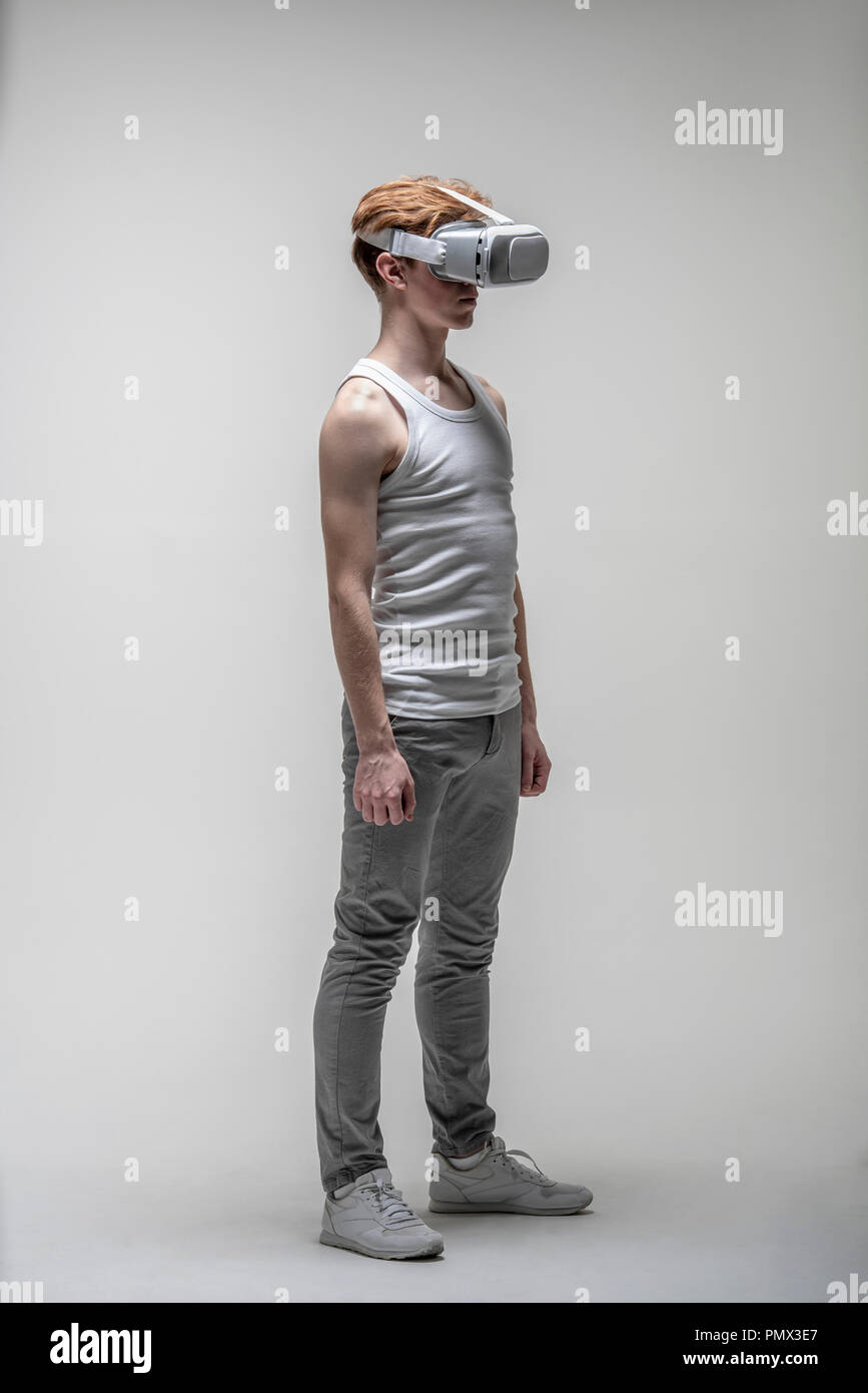 Young man using virtual reality simulator glasses Stock Photo
