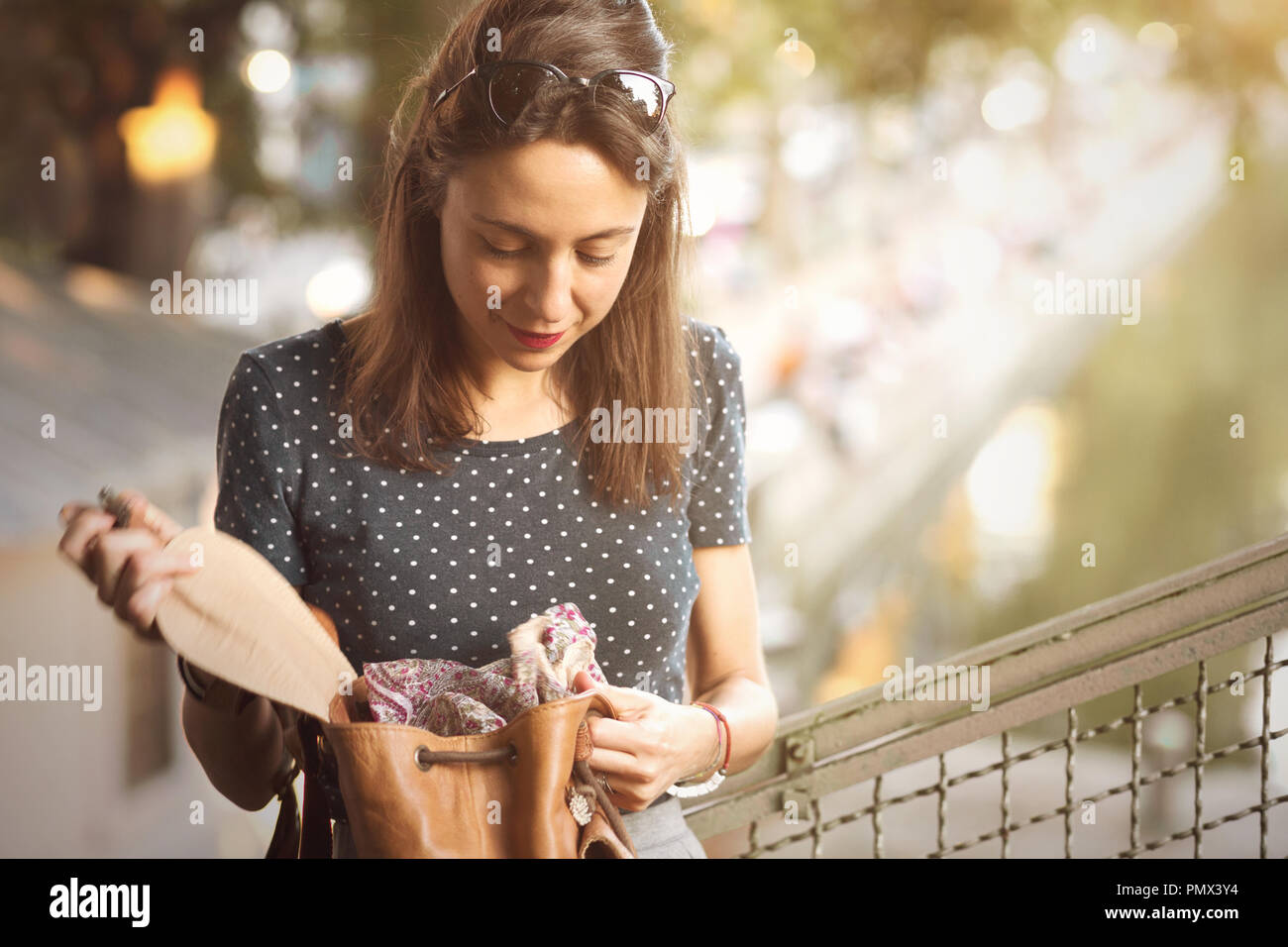 Young woman looking inside her bag Stock Photo