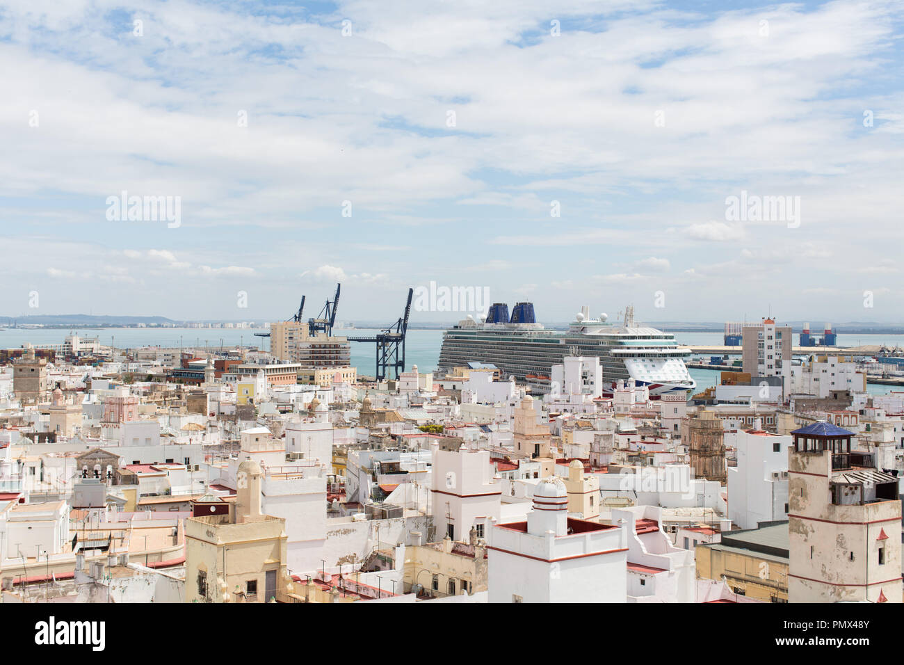 A view looking down on the rooftops of the city of Cadiz in Spain from the Tavira Tower (camera obscura) with a cruise ship in port in the distance Stock Photo