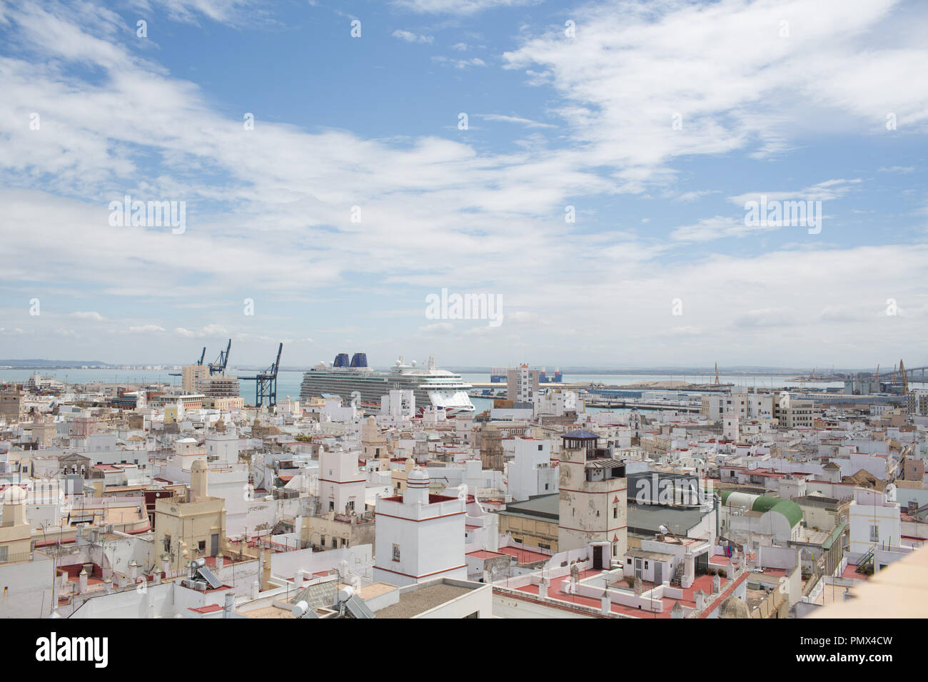A view looking down on the rooftops of the city of Cadiz in Spain from the Tavira Tower (camera obscura) with a cruise ship in port in the distance Stock Photo