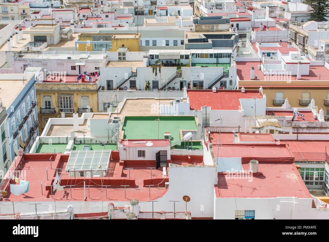 View looking down on rooftops from the Tavira Tower (Camera Obscura) in the city of Cadiz in Spain. Flat roof and colourful buildings. Stock Photo