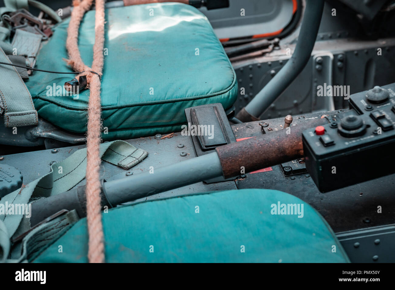 Details inside piloting cabin of a bomb carrier. Ejection seat and safety belts with all the emergency levers and controls. Military vehicle, setup. Stock Photo