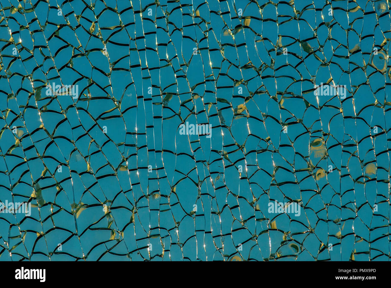 Pattern of ice or crackled glass. Shiny cracks, grunge surface. Blue and white colors. Decorative texture or background Stock Photo