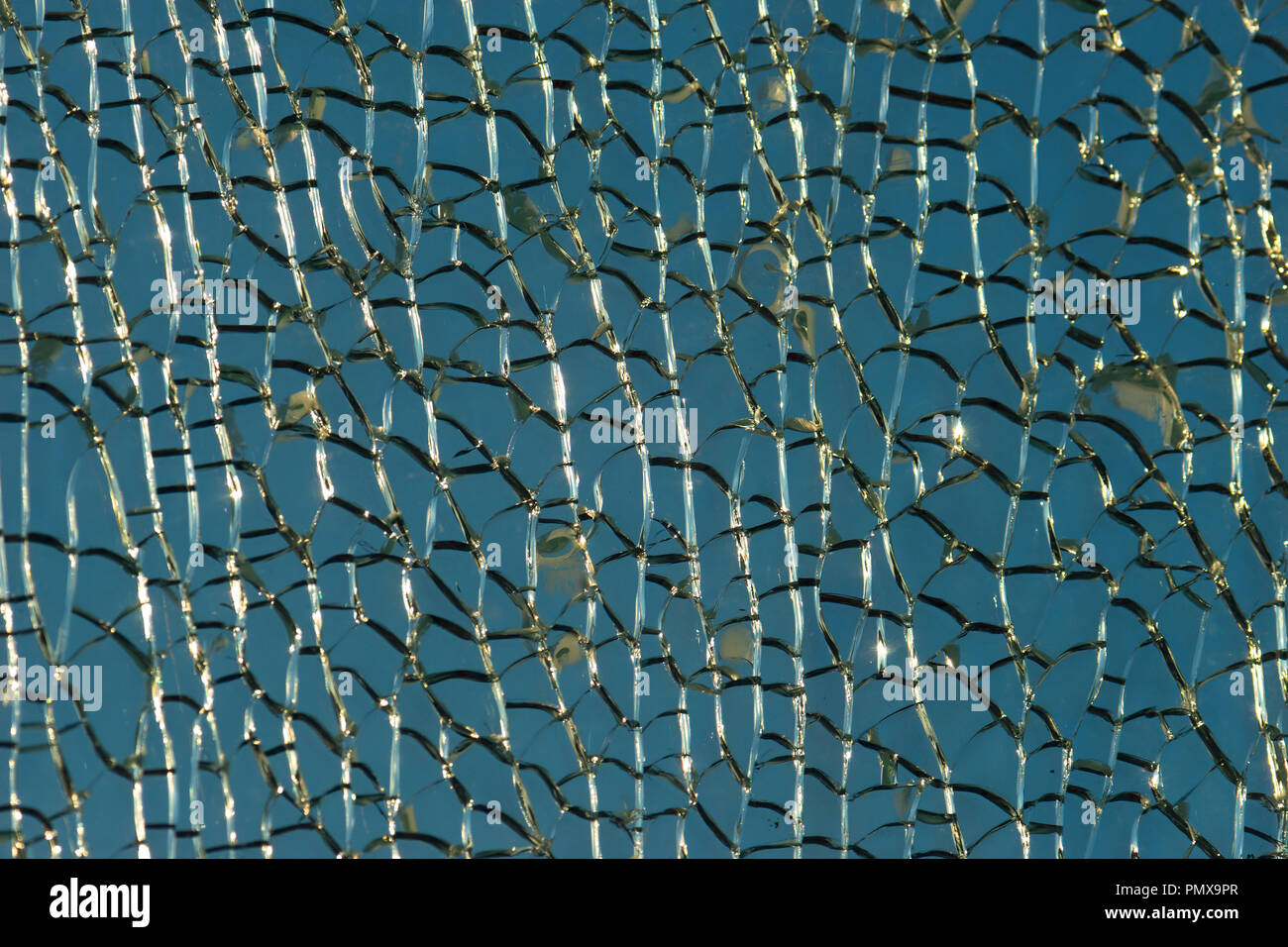 Pattern of ice or crackled glass. Shiny cracks, grunge surface. Blue and white colors. Decorative texture or background Stock Photo