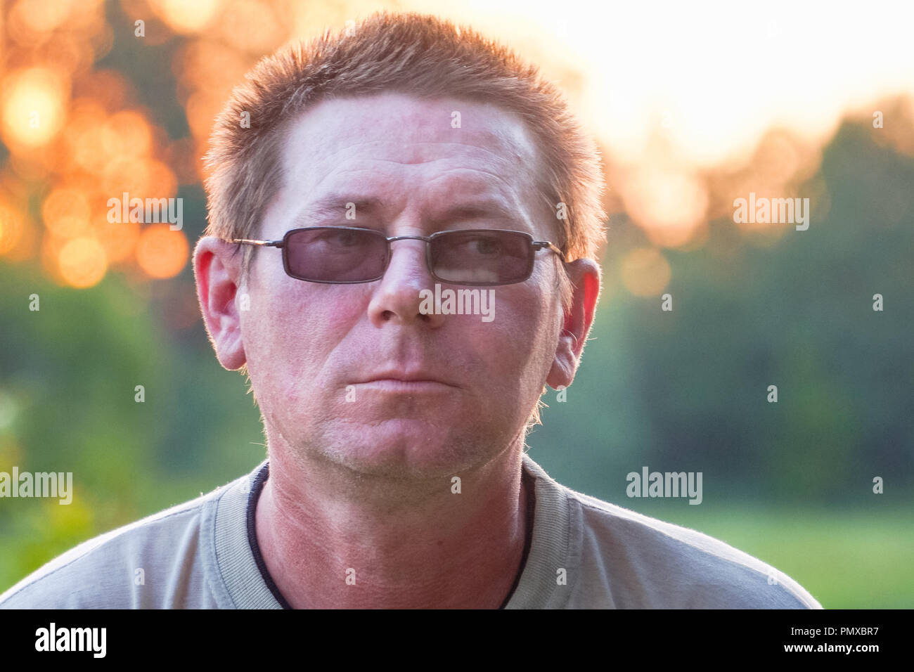 Portrait of a man in dark glasses with sloppy hair Stock Photo