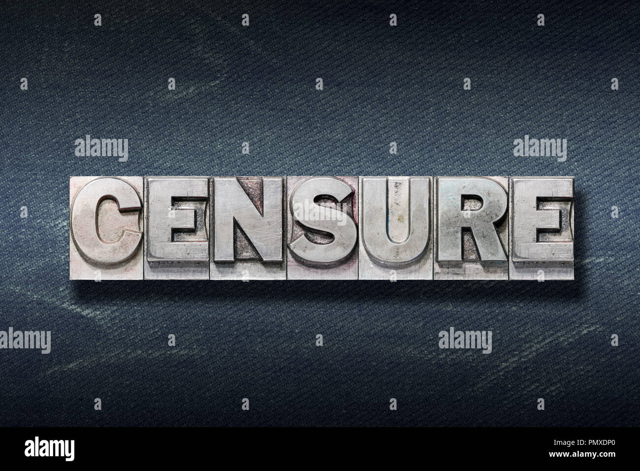 censure word made from metallic letterpress on dark jeans background Stock Photo