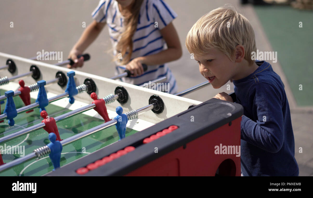 modern life in a big city children play table hockey on the street