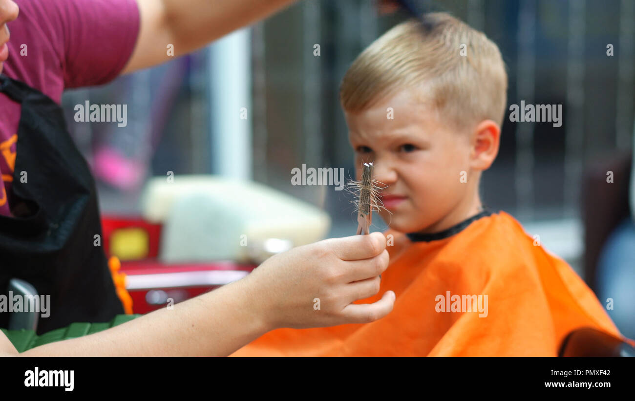 haircut of a little boy in a children's hairdressing salon Stock Photo
