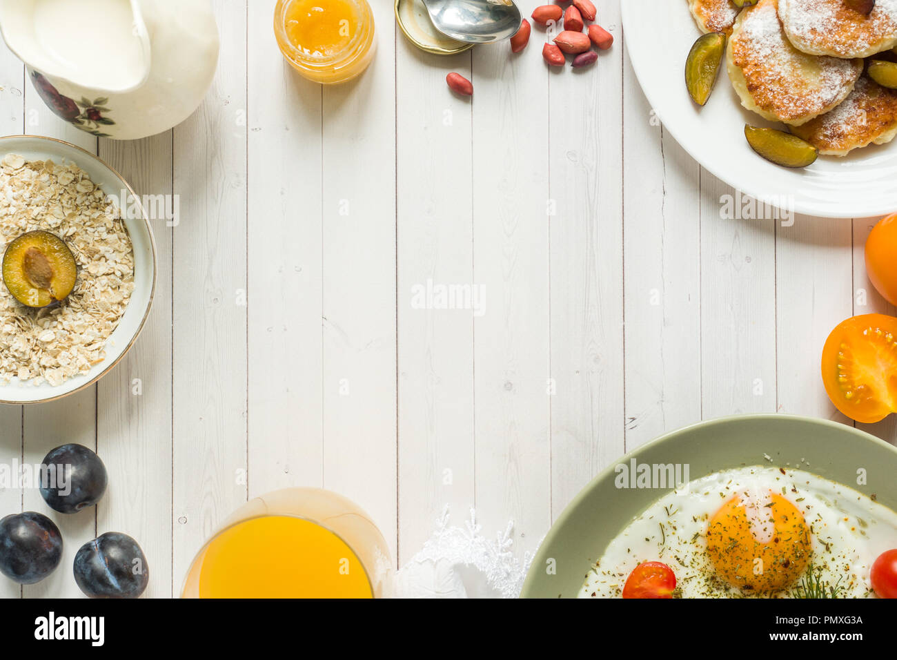 Concept Of Breakfast Fried Eggs Cottage Cheese Pancakes Plums