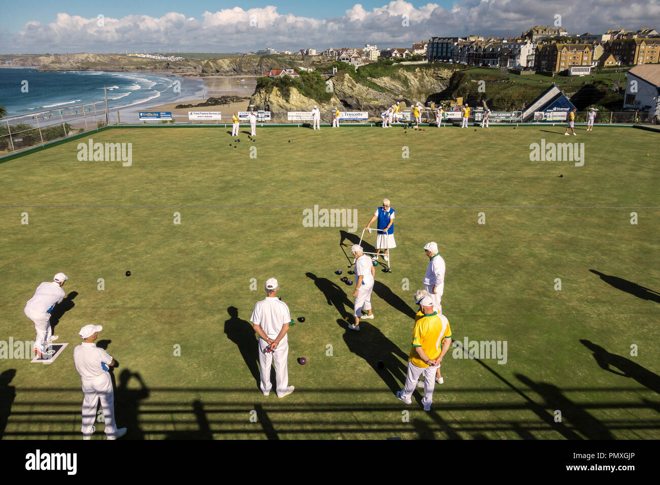 Newquay, Cornwall, UK. A bowls team playing a match on the bowling green, which overlooks the town and the sea Stock Photo
