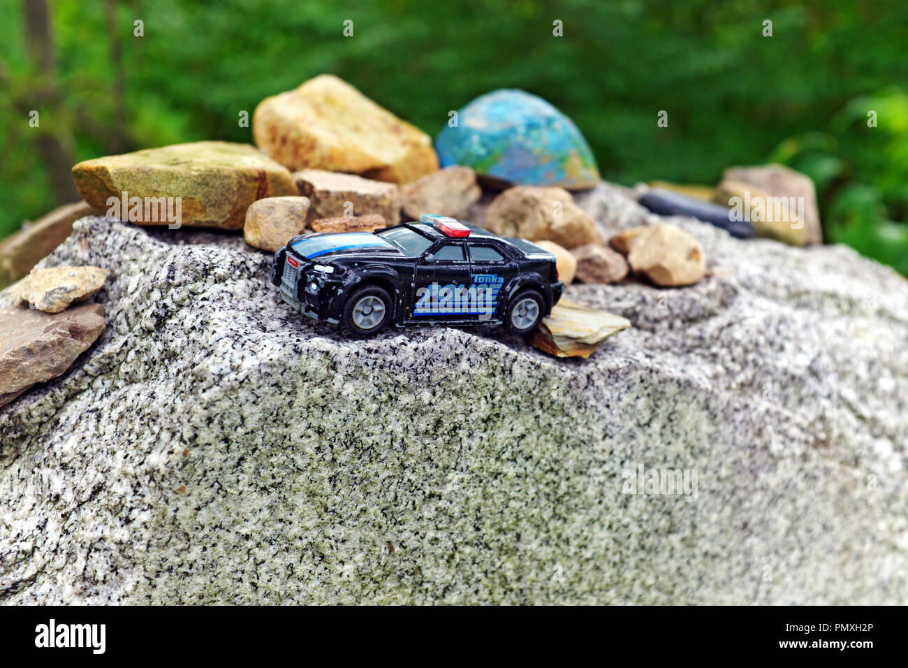 A Tonka toy police car rests on top of the headstone of Elliott Ness, most known for taking down Al Capone, in Lake View Cemetery in Cleveland, Ohio. Stock Photo