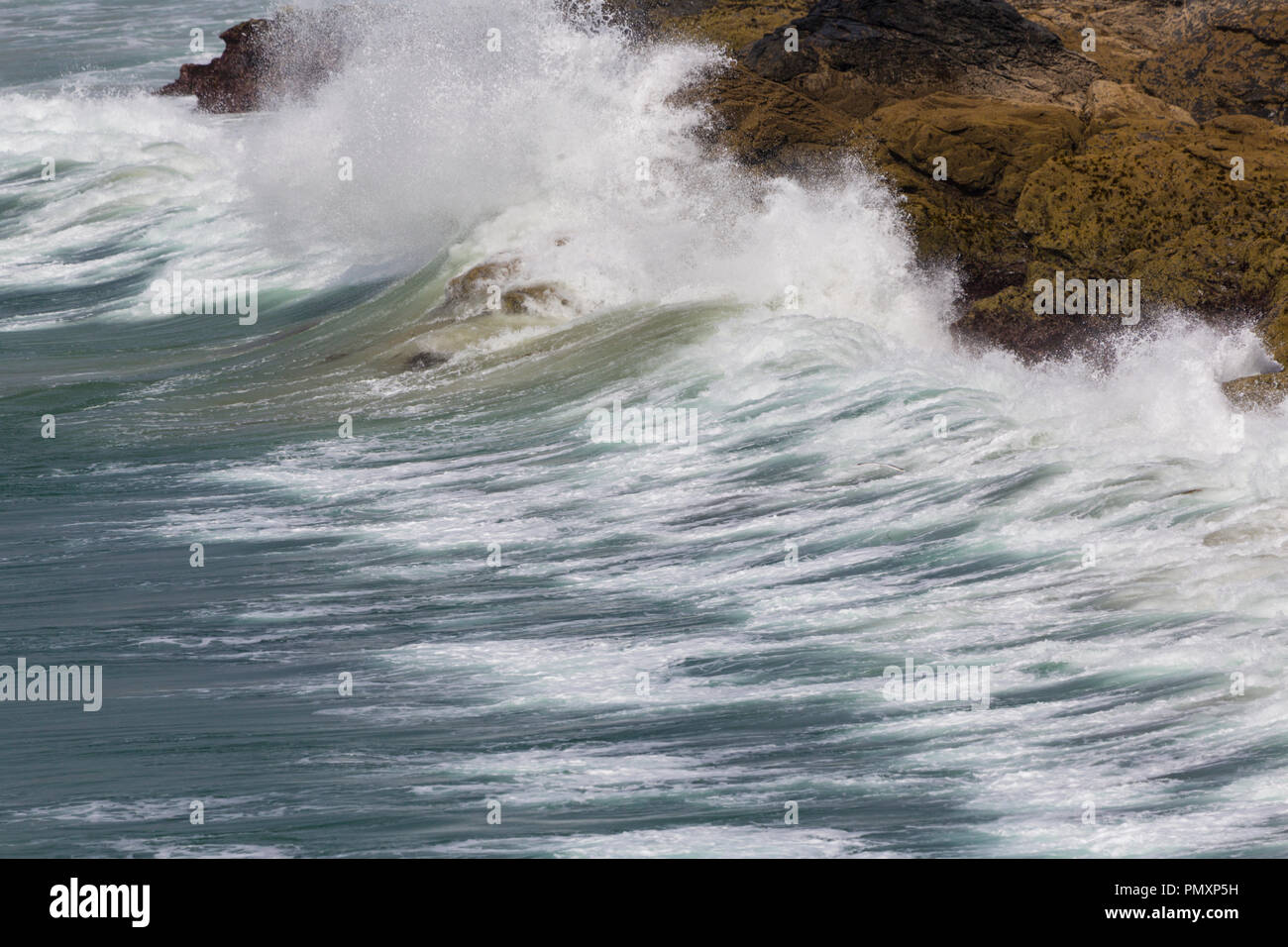 Waves off Church Cove Gunwalloe on the Lizard Coast of Cornwall Stock Photo