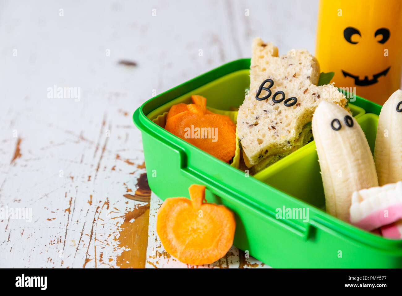 Halloween style school lunch box ghost sandwich, pumpkin carrots