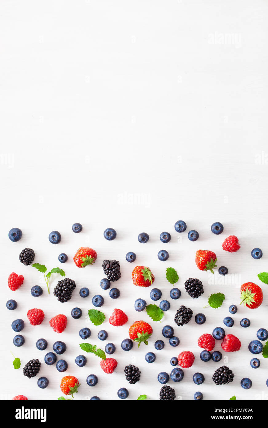 assorted berries over white background. blueberry, strawberry, raspberry, blackberry Stock Photo