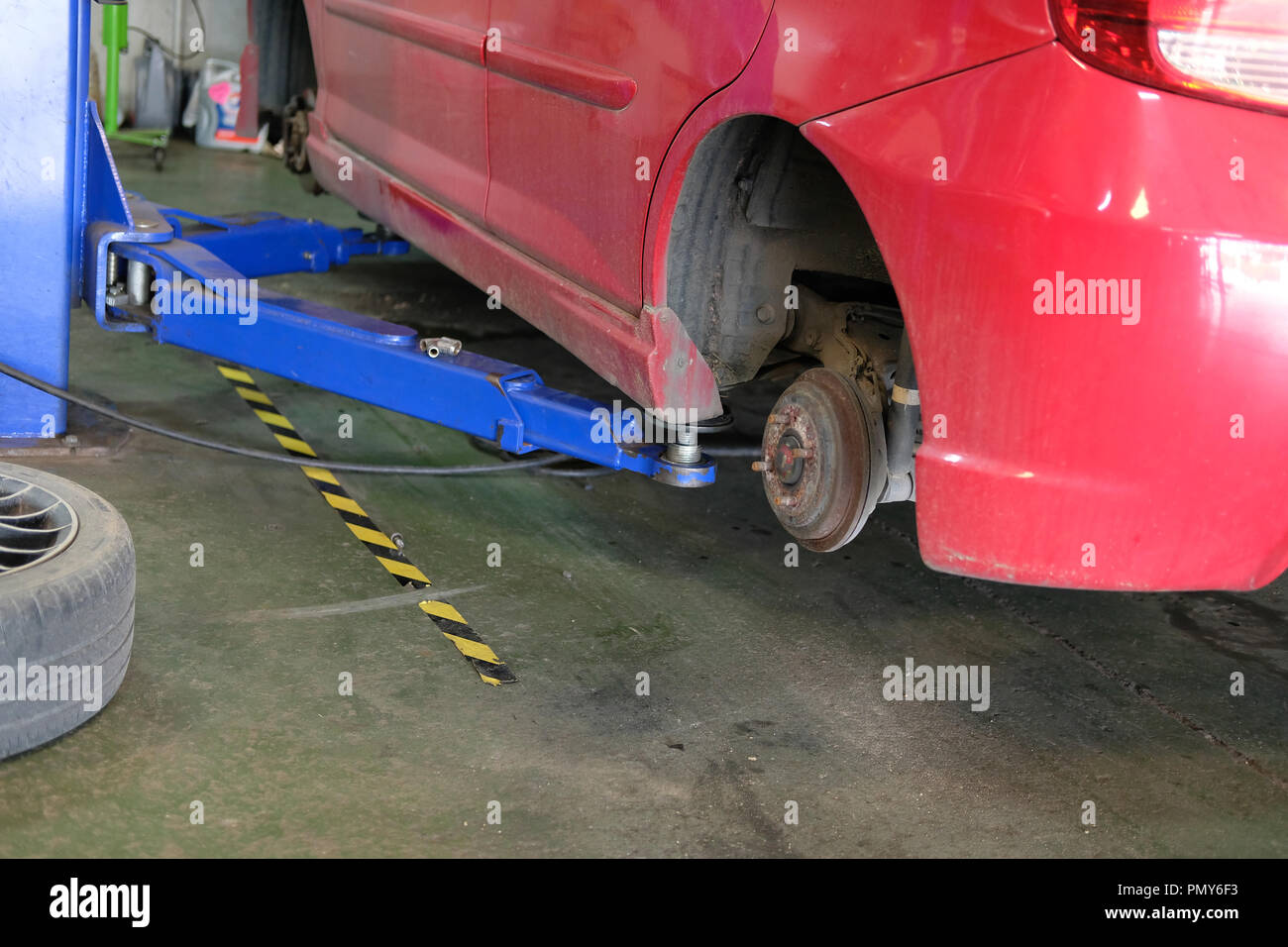 car on lift in automobile service repair garage Stock Photo - Alamy
