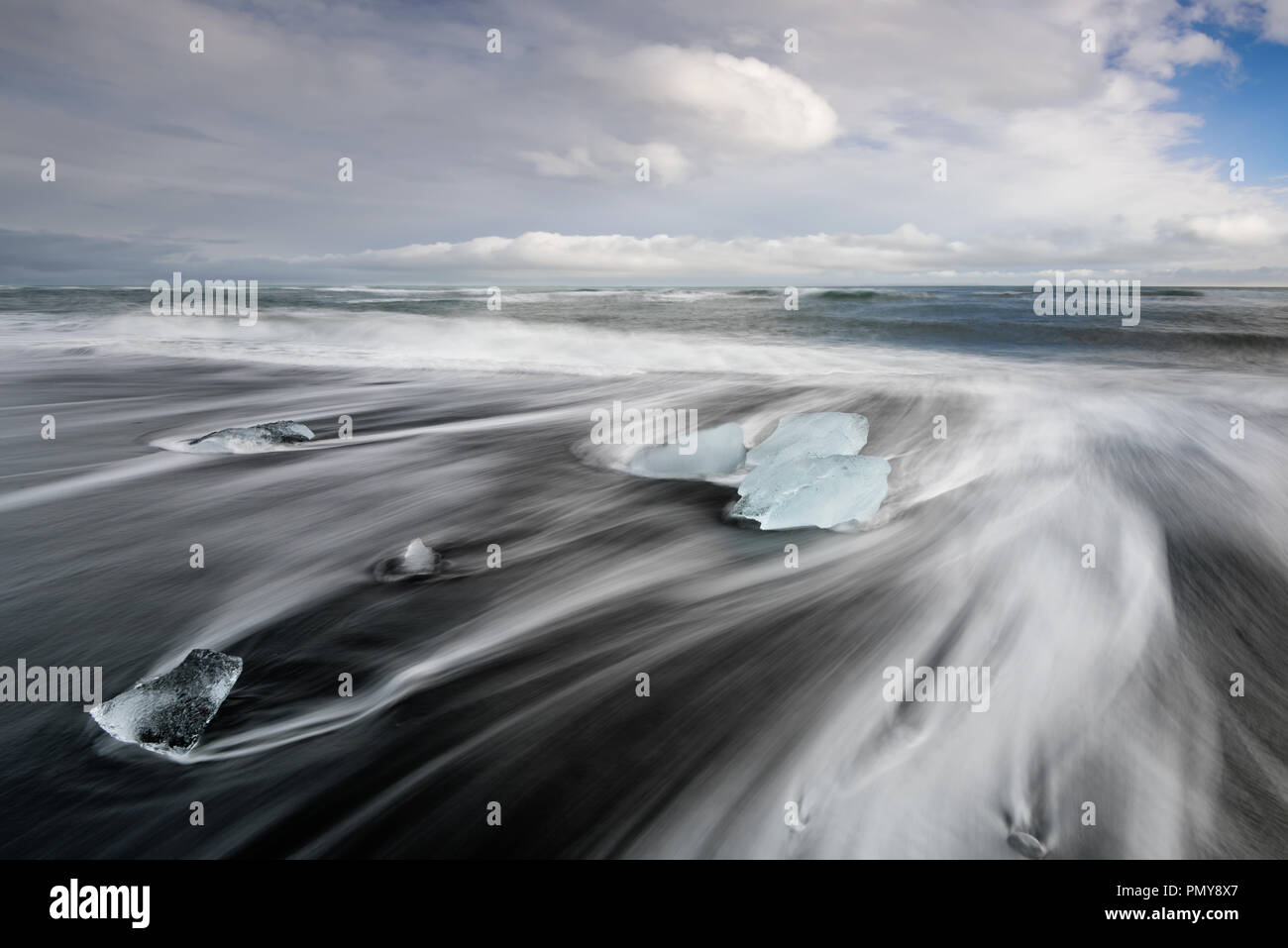 Iceland Diamond Beach, Glacier Lagoon icebergs form abstract shapes in the ocean at Black