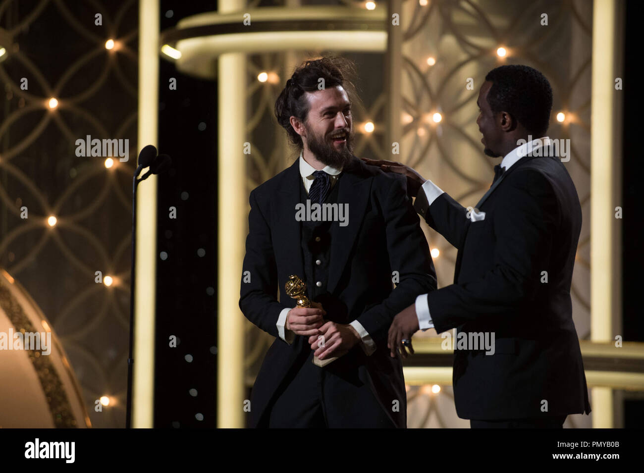 The Golden Globe is awarded to Alex Ebert for BEST ORIGINAL SCORE – MOTION PICTURE for “ALL IS LOST” from Sean Combs at the 71st Annual Golden Globe Awards at the Beverly Hilton in Beverly Hills, CA on Sunday, January 12, 2014.  File Reference # 32222 506JRC  For Editorial Use Only -  All Rights Reserved Stock Photo