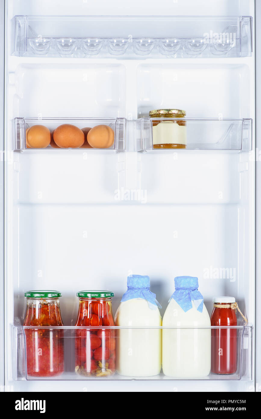 https://c8.alamy.com/comp/PMYC5M/eggs-preserved-tomatoes-and-bottles-of-milk-in-fridge-PMYC5M.jpg