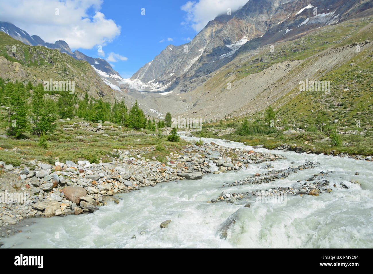 View up the Lochstal Valley and the Lonza glacial stream to the Lotschenlucke Pass in the Bernese Alps, Switzerland. High above the Annen Hut Refuge Stock Photo